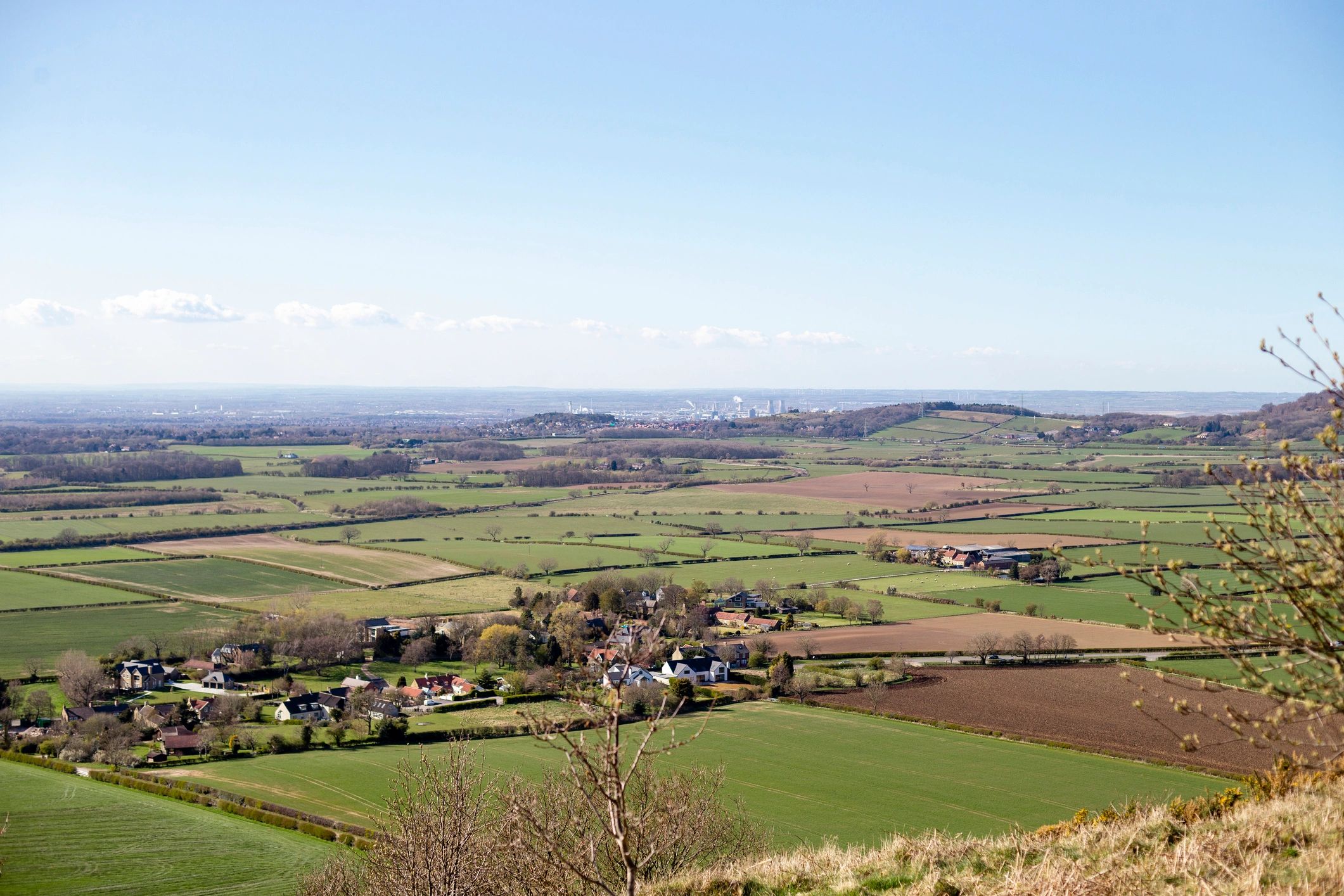 Countryside landscape view with fields and distant houses
