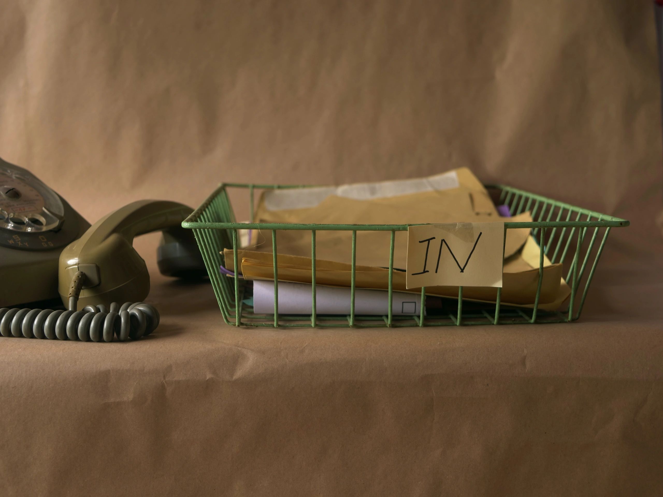 Office desk with in-tray and telephone