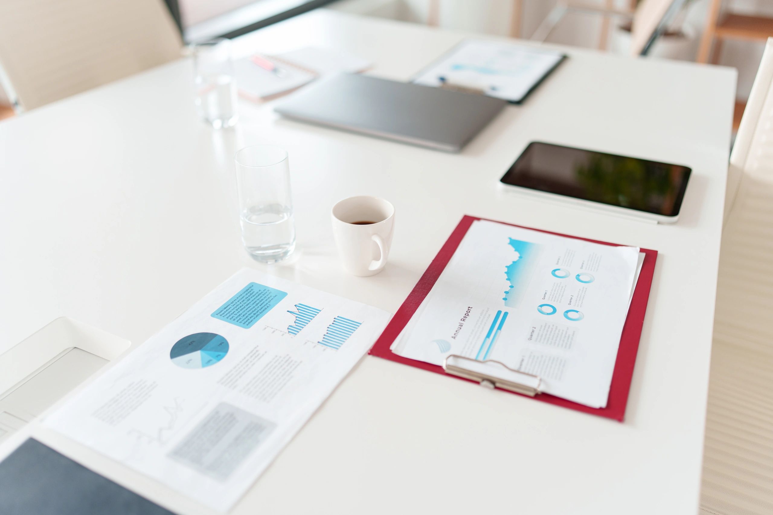 Reports and devices arranged on a meeting table