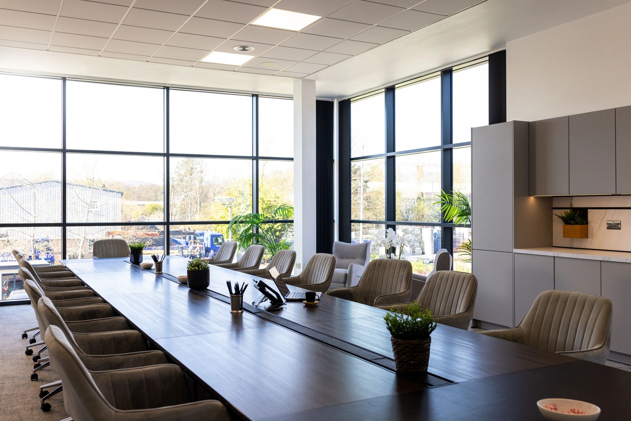Empty meeting room with conference table and windows